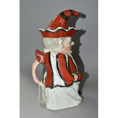 435 - A STAFFORDSHIRE TOBY JUG IN THE FORM OF MR PUNCH, with red, black and white striped outfit, the hat ... 