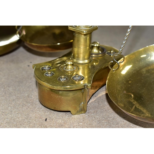 482 - TWO SETS OF VICTORIAN BRASS SCALES, comprising one set with chains and pans on a brass stand, height... 