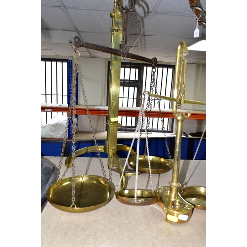 482 - TWO SETS OF VICTORIAN BRASS SCALES, comprising one set with chains and pans on a brass stand, height... 