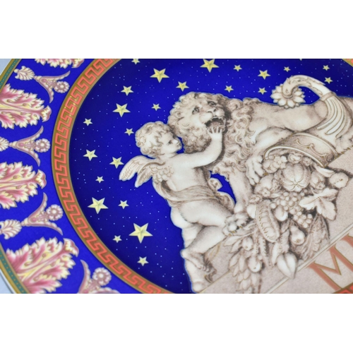 527 - TWO ROSENTHAL FOR VERSACE CHRISTMASTIDE 2000 PLATES, depicting a cherub, lion and cornucopia statue ... 