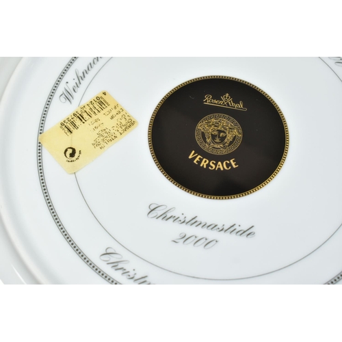 527 - TWO ROSENTHAL FOR VERSACE CHRISTMASTIDE 2000 PLATES, depicting a cherub, lion and cornucopia statue ... 