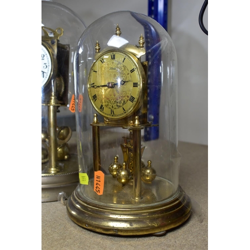 555 - TWO GLASS DOMED CLOCKS, comprising a  West German 400 day anniversary clock 'Kieninger & Obergfell' ... 