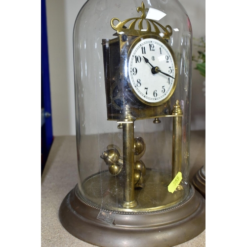 555 - TWO GLASS DOMED CLOCKS, comprising a  West German 400 day anniversary clock 'Kieninger & Obergfell' ... 