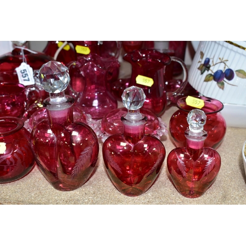 557 - A COLLECTION OF CRANBERRY GLASSWARE, comprising two cut glass decanters, height 26cm, 15cm, with cle... 