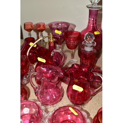 557 - A COLLECTION OF CRANBERRY GLASSWARE, comprising two cut glass decanters, height 26cm, 15cm, with cle... 