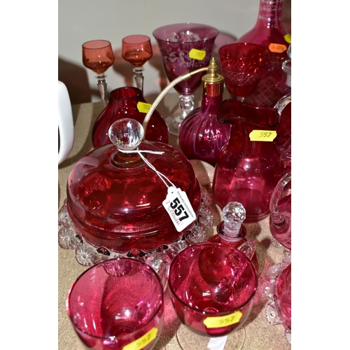 557 - A COLLECTION OF CRANBERRY GLASSWARE, comprising two cut glass decanters, height 26cm, 15cm, with cle... 