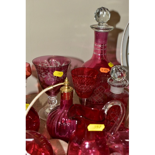 557 - A COLLECTION OF CRANBERRY GLASSWARE, comprising two cut glass decanters, height 26cm, 15cm, with cle... 