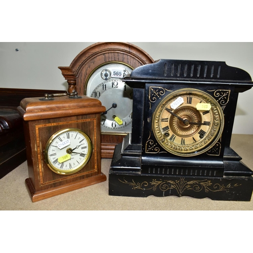 565 - A COLLECTION OF FIVE CLOCKS, to include a late 19th century black slate mantel clock, made by Ansoni... 