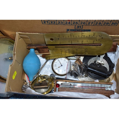 574 - TWO BOXES OF SPARE PARTS FOR BAROMETERS AND CLOCKS,  to include brass frames, faces, glass fronts an... 