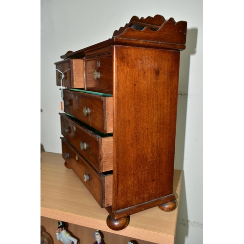 582 - A MINIATURE MAHOGANY CHEST OF DRAWS WITH GALLERIED MIRROR, having two short draws over three long dr... 