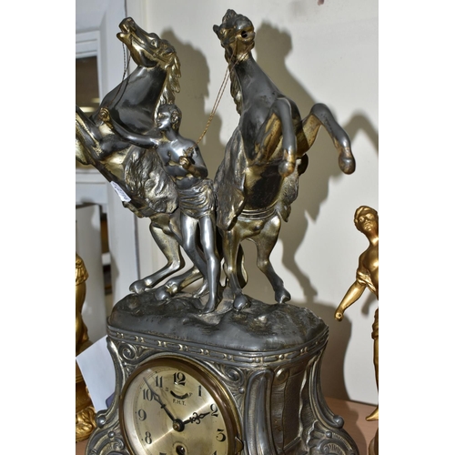 583 - A FRENCH STYLE PEWTER CLOCK GARNITURE, the metal dial marked F.H.T with Arabic numerals, the case is... 