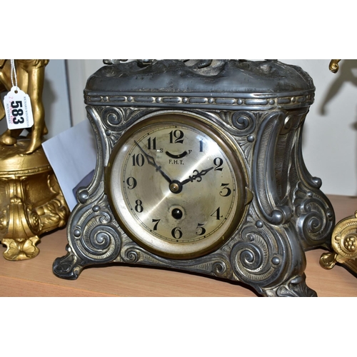 583 - A FRENCH STYLE PEWTER CLOCK GARNITURE, the metal dial marked F.H.T with Arabic numerals, the case is... 