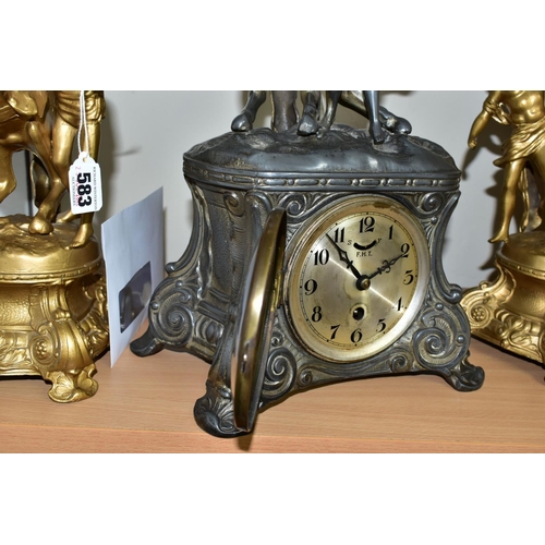 583 - A FRENCH STYLE PEWTER CLOCK GARNITURE, the metal dial marked F.H.T with Arabic numerals, the case is... 