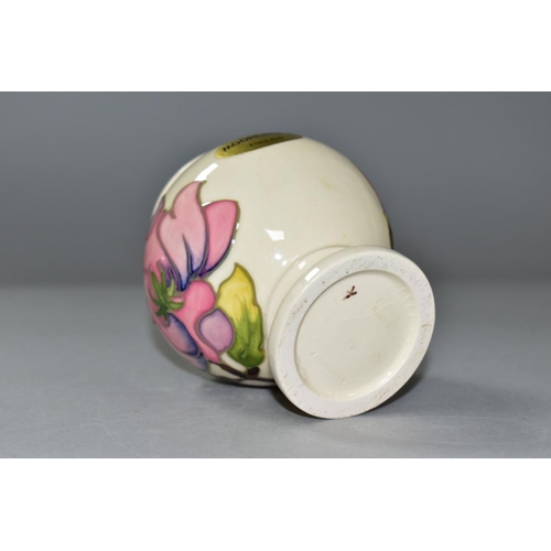 590 - A MOORCROFT PINK MAGNOLIA PATTERN, URN SHAPED VASE, approximate height 9cm, gold foil label to the b... 