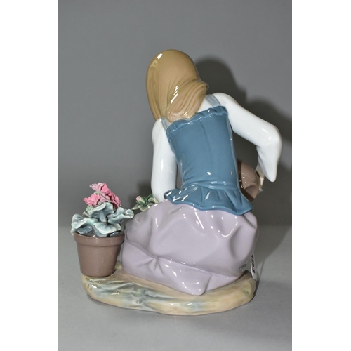 591 - LLADRO FIGURINE 'WATERING THE FLOWER POTS', a young girl is holding a pitcher of water to water plan... 