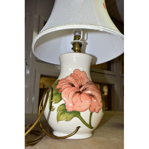 648 - A MOORCROFT POTTERY TABLE LAMP BASE DECORATED WITH A CORAL 'HIBISCUS' DESIGN ON A CREAM BACKGROUND, ... 