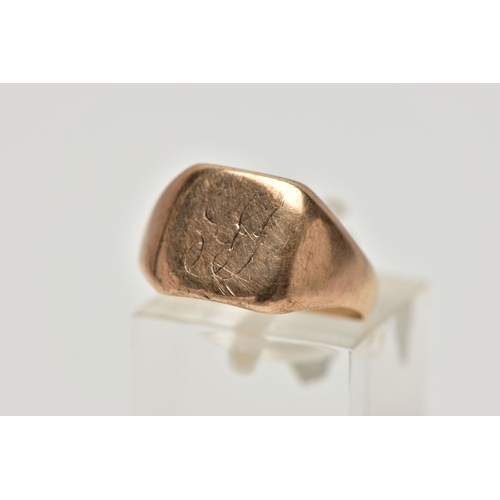 13 - A YELLOW METAL SIGNET RING, square polished signet with worn engraved initials, tapered polished sho... 