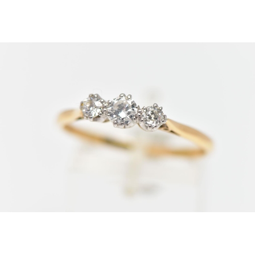 78 - A MID 20TH CENTURY PLATINUM AND 18CT YELLOW GOLD DIAMOND THREE STONE RING, set with a principal roun... 