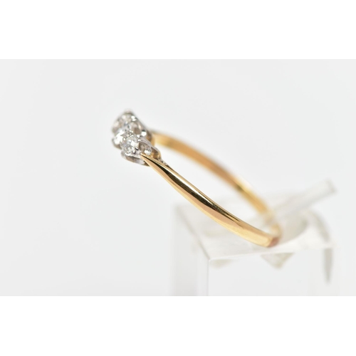 78 - A MID 20TH CENTURY PLATINUM AND 18CT YELLOW GOLD DIAMOND THREE STONE RING, set with a principal roun... 