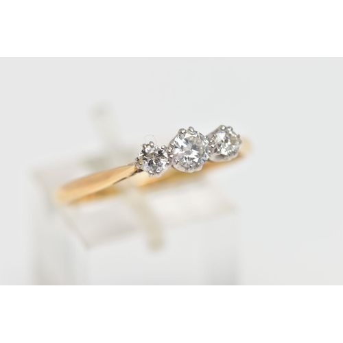 78 - A MID 20TH CENTURY PLATINUM AND 18CT YELLOW GOLD DIAMOND THREE STONE RING, set with a principal roun... 