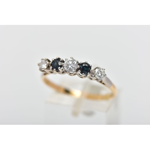 79 - A YELLOW AND WHITE METAL DIAMOND AND SAPPHIRE FIVE STONE RING, set with three graduating round brill... 