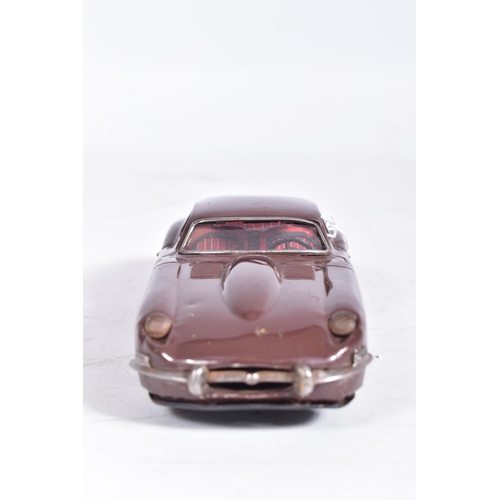 87 - AN UNBOXED NOMURA TINPLATE FRICTION DRIVE JAGUAR E TYPE, metallic blue body, red and white interior,... 