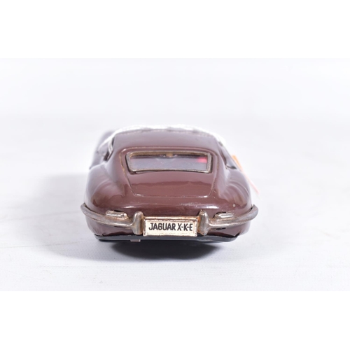 87 - AN UNBOXED NOMURA TINPLATE FRICTION DRIVE JAGUAR E TYPE, metallic blue body, red and white interior,... 