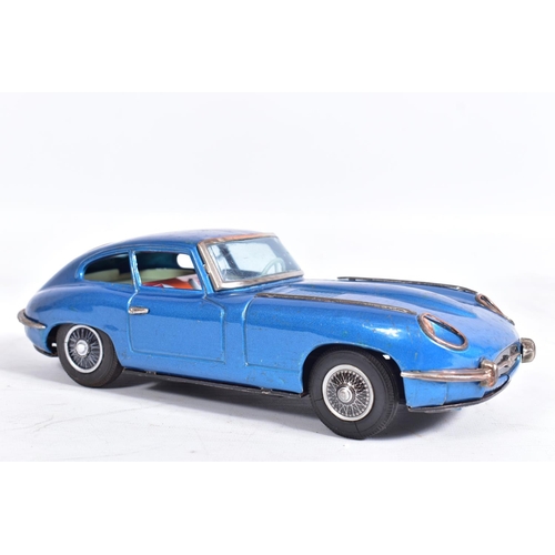 87 - AN UNBOXED NOMURA TINPLATE FRICTION DRIVE JAGUAR E TYPE, metallic blue body, red and white interior,... 