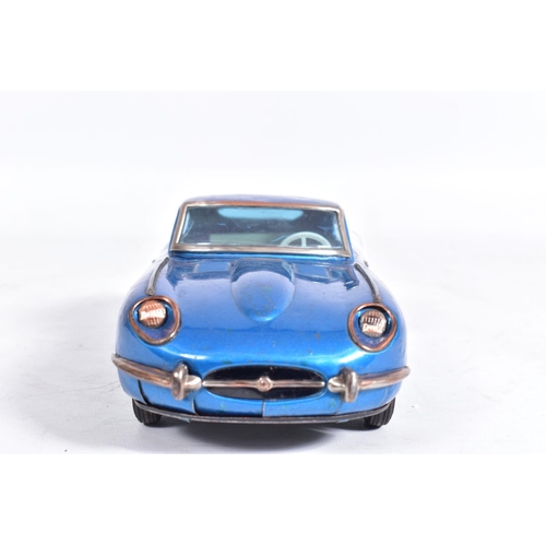 87 - AN UNBOXED NOMURA TINPLATE FRICTION DRIVE JAGUAR E TYPE, metallic blue body, red and white interior,... 