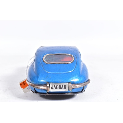 87 - AN UNBOXED NOMURA TINPLATE FRICTION DRIVE JAGUAR E TYPE, metallic blue body, red and white interior,... 