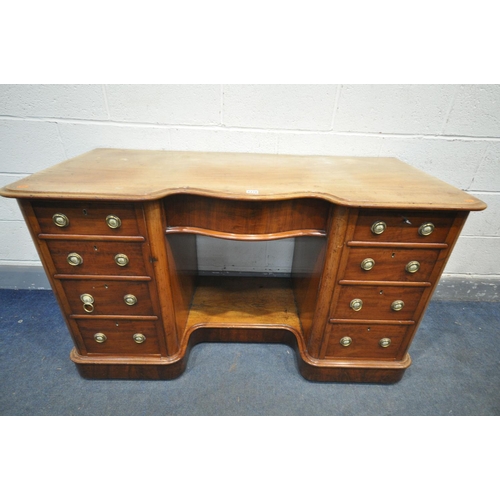 1196 - A VICTORIAN MAHOGANY KNEE HOLE DESK, serpentine centre, over a single frieze drawer, flanked by two ... 