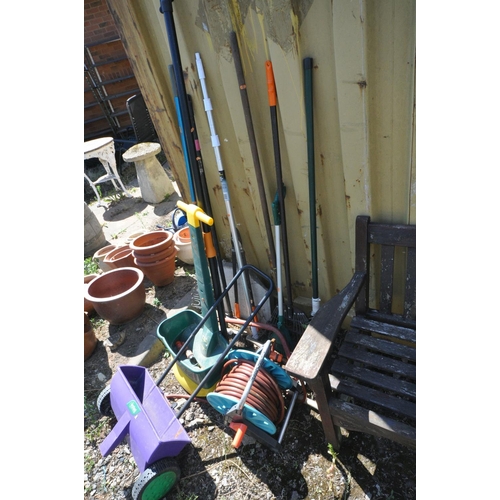 1019 - A SELECTION OF GARDEN HAND TOOLS, to include rakes, brushes, loppers, etc, along with a hose reel wi... 