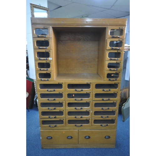 1201 - A MID-CENTURY BEECH HABERDASHERY CABINET, made up of two banks of five glass front drawers that's fl... 