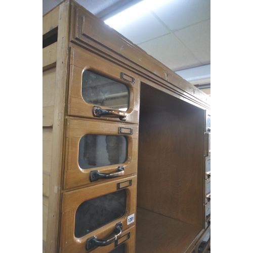 1201 - A MID-CENTURY BEECH HABERDASHERY CABINET, made up of two banks of five glass front drawers that's fl... 