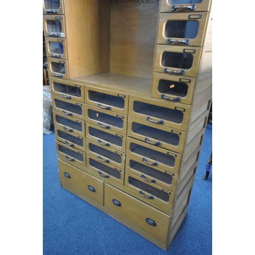 1201 - A MID-CENTURY BEECH HABERDASHERY CABINET, made up of two banks of five glass front drawers that's fl... 