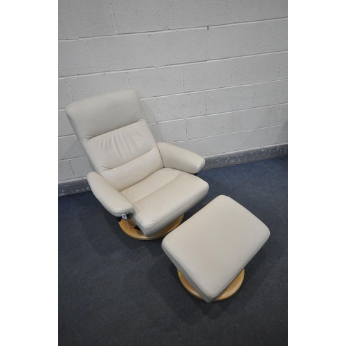 1202 - A CREAM LEATHER EKORNES STRESSLESS SWIVEL RECLINING ARMCHAIR, on a beech frame, and a matching foot ... 