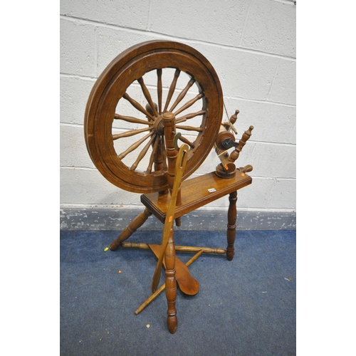 1210 - A MID CENTURY BEECH AND MAHOGANY SPINNING WHEEL (condition:-missing pin to foot pedal)