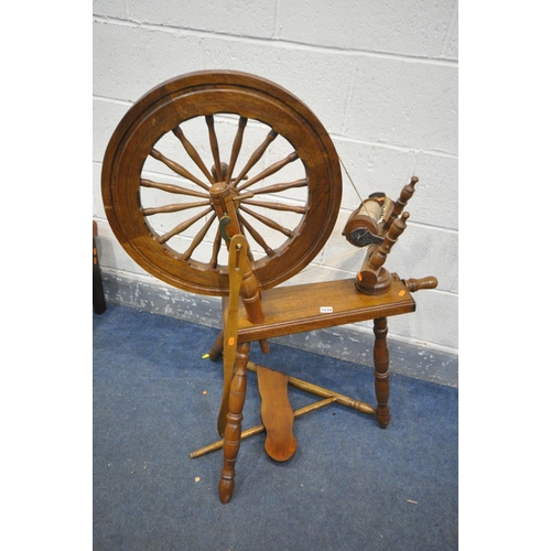 1210 - A MID CENTURY BEECH AND MAHOGANY SPINNING WHEEL (condition:-missing pin to foot pedal)