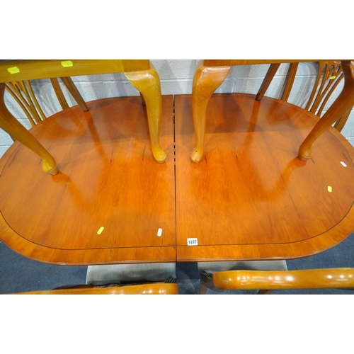 1227 - A YEW WOOD EXTENDING DINING TABLE, one fold out leaf, along with a matched set of six yew wood dinin... 