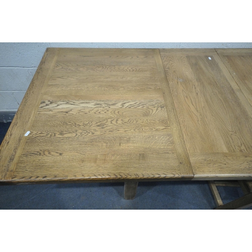 1232 - A SOLID OAK EXTENDING DINING TABLE, with two additional leaves, open length 226cm x closed 150cm x d... 