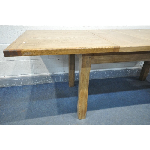 1232 - A SOLID OAK EXTENDING DINING TABLE, with two additional leaves, open length 226cm x closed 150cm x d... 