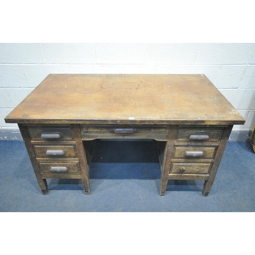 1235 - A 1940'S OAK DESK, with six assorted drawers, with later fitted Bakelite handles, width 143cm x dept... 