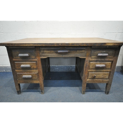 1235 - A 1940'S OAK DESK, with six assorted drawers, with later fitted Bakelite handles, width 143cm x dept... 