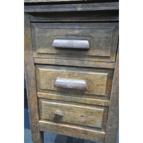 1235 - A 1940'S OAK DESK, with six assorted drawers, with later fitted Bakelite handles, width 143cm x dept... 