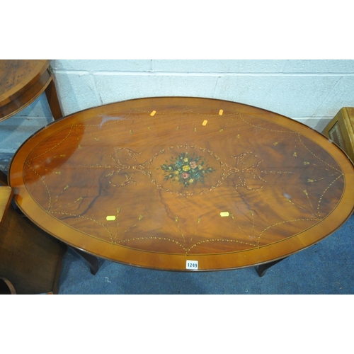 1249 - AN OVAL MAHOGANY AND INLAID COFFEE TABLE, with splayed legs, united by stretchers, length 112cm x de... 