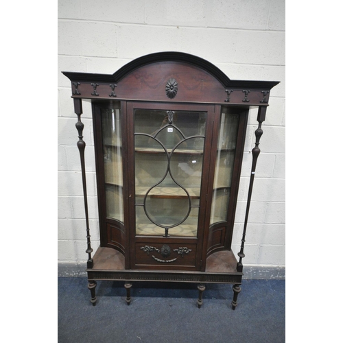 1252 - AN EARLY 20TH CENTURY MAHOGANY DISPLAY CABINET,  with concave glass panels, and turned supports, fla... 