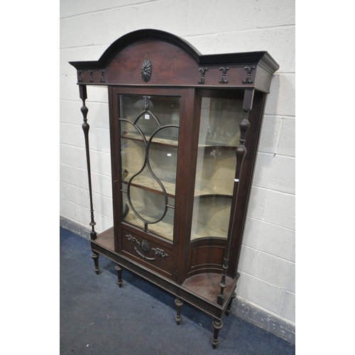 1252 - AN EARLY 20TH CENTURY MAHOGANY DISPLAY CABINET,  with concave glass panels, and turned supports, fla... 