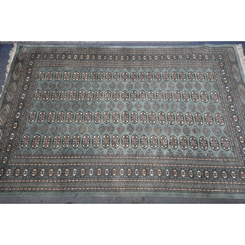 1254 - A KAYAM PAKISTAN TEAL GROUND RUG, with a multistrap border, and eighty four medallions, length 250cm... 