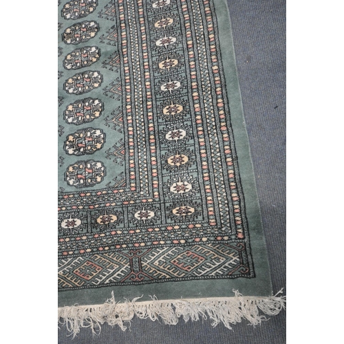 1254 - A KAYAM PAKISTAN TEAL GROUND RUG, with a multistrap border, and eighty four medallions, length 250cm... 