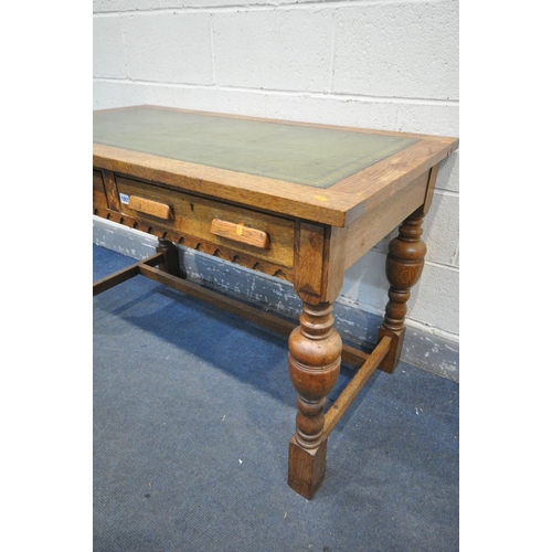 1257 - A 20TH CENTURY SOLID OAK WRITING DESK, with green leather inlay, two frieze drawers, on acorn legs, ... 